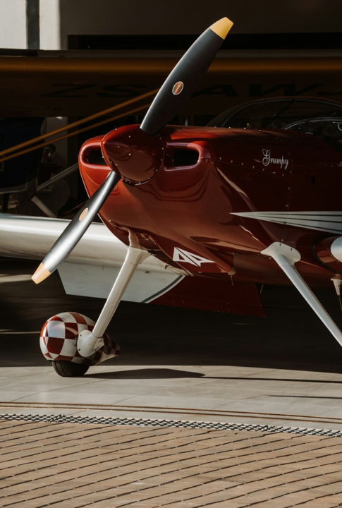 red and white airplane in a parking lot