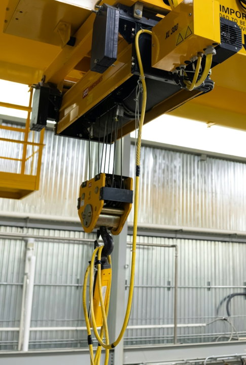 yellow-industrial-overhead-crane-with-hoist-and-cables.jpg Yellow industrial overhead crane with hoist and cables
